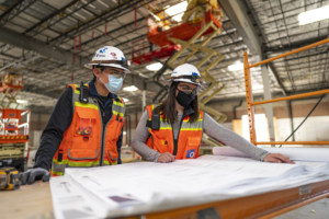 Two women looking at a blueprint